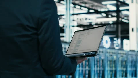 Close up of data center engineer using laptop to code Stock Footage 329945142