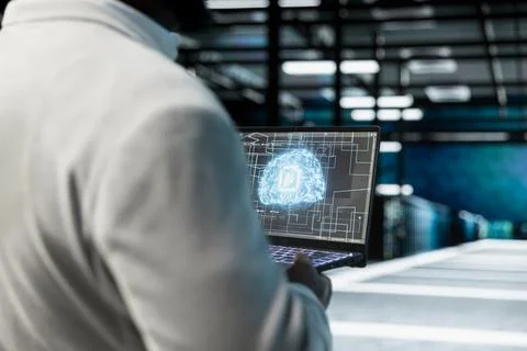Close up of data center engineer using AI on laptop, performing gear maintenance 写真素材