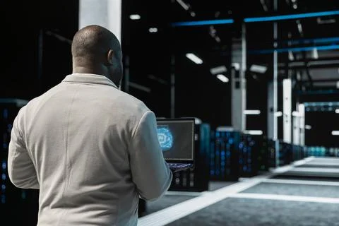 Close up of data center engineer using AI on laptop to optimize performance Stock Photos