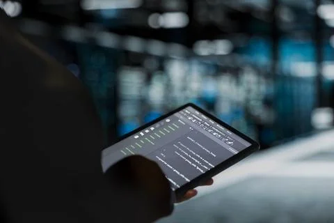 Close up of data center engineer using tablet to troubleshoot backend operations 写真素材