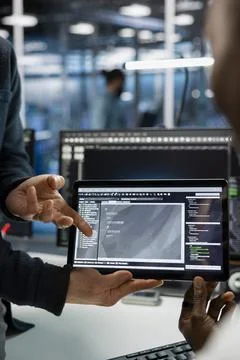 Close up of data center IT staff members coding on tablet, deploying servers Stock-Fotos