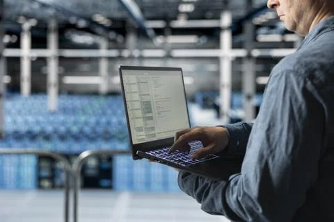 Close up of data center programmer coding on laptop, monitoring error logs Stock-Fotos