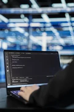 Close up of data center programmer coding on laptop Stock-Fotos