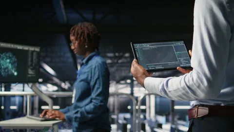 Close up of data center programmer looking at code debugging tools on tablet Stock Footage 310276089