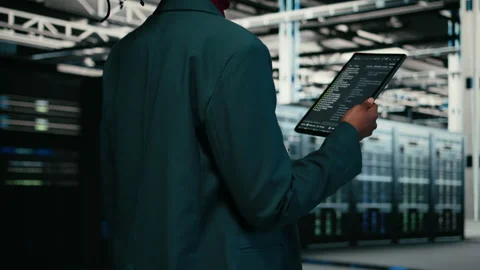 Close up of data center programmer using tablet app to write code Stock Footage 329652331
