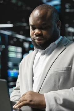 Close up of data center programmer using laptop to protect servers 스톡 사진