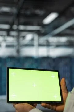Close up of data center programmer using green screen tablet in data center Stock-Fotos