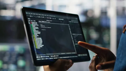 Close up of data center software developer checking code on tablet Stock Footage 307018987
