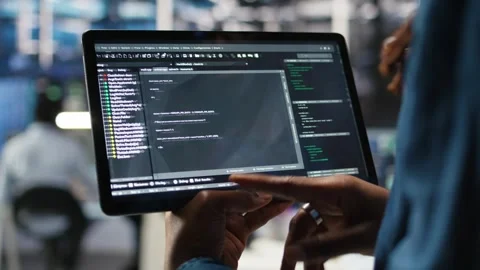 Close up of data center software developer checking code on tablet Stock Footage 309511208
