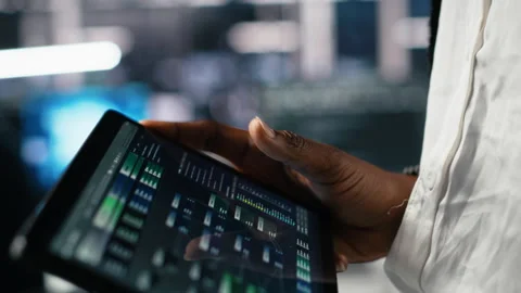 Close up of data center software developer using tablet to review code Stock Footage 313566179