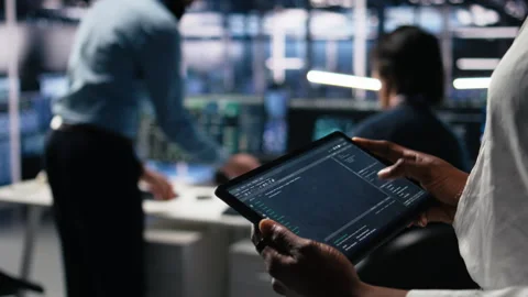 Close up of data center software developer using tablet to review code Stock Footage 313637095