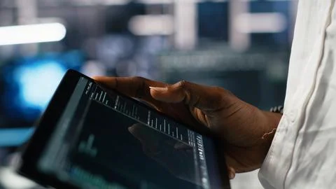 Close up of data center software developer using tablet to review code Stock Photos