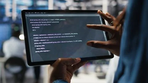 Close up of data center software developer checking code on tablet Foto stock