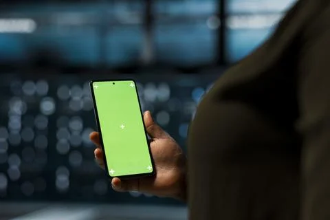 Close up of data center software developer using green screen smartphone Stock Photos