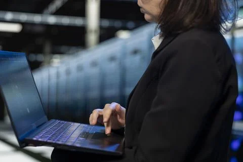 Close up of data center software developer using laptop to review diagnostics 스톡 사진