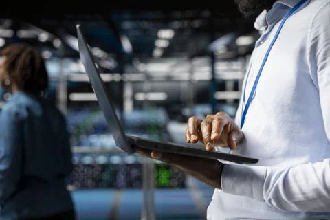 Close up of data center software engineer doing maintenance work on laptop Stock Photos