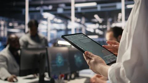 Close up of data center system administrator coding on tablet 스톡 사진