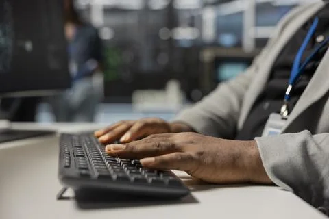 Close up of data center technician typing on keyboard, inspecting gear Stock Photos