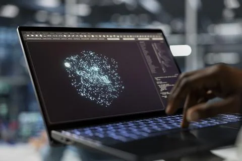 Close up of data center technician using laptop, running AI simulations 스톡 사진