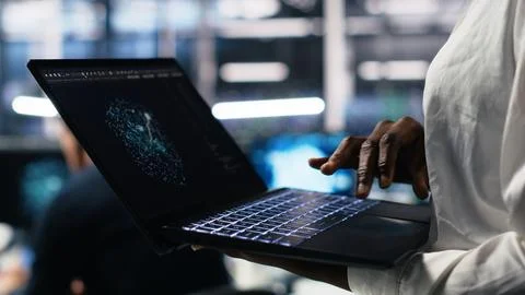Close up of data center technician using tablet to monitor neural network AI LLM 스톡 사진