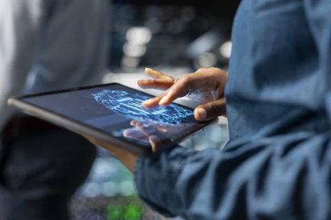 Close up of data center technician using tablet for maintenance on server rigs Stock Photos