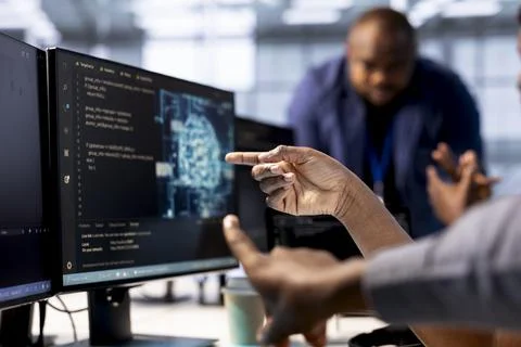 Close up of data center worker pointing finger to AI tech on PC screen Foto stock