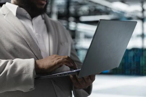 Close up of data center worker running error checking utilities on laptop 写真素材
