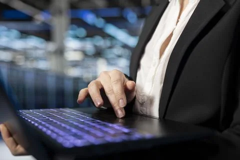 Close up of data center worker typing on laptop to install and configure gear Stock Photos