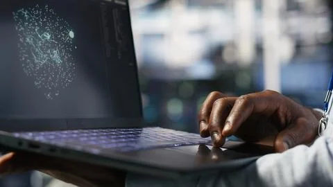 Close up of data center worker using laptop to interpret AI data analytics Stock Photos