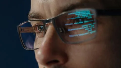 Close up of data scientist face is closely examines data Stock Photos