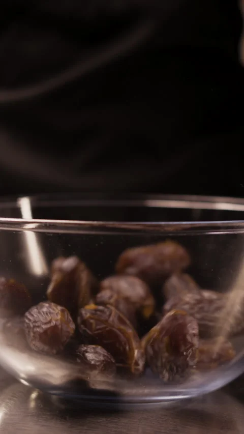 Close-Up of Dates Falling into a Glass Bowl Video stock 306169733