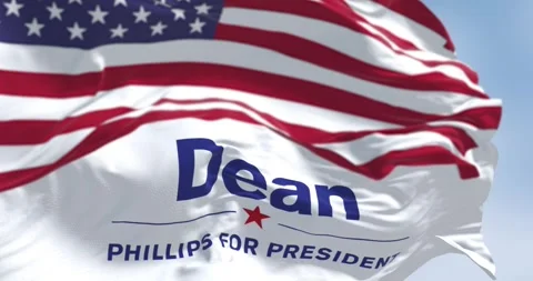 Close-up of Dean Phillips election campaign flag and the American flag waving Stock Footage 255824510