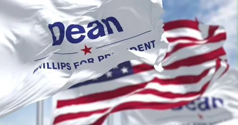 Close-up of Dean Phillips election campaign flag and the American flag waving Stock Footage 256237308