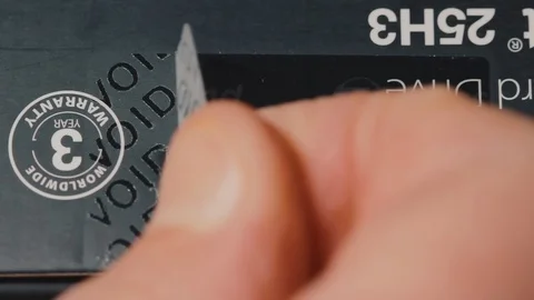 Close-up of the decal of the warranty sticker on the packaging Stock Footage 103185396