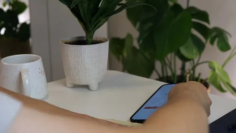 Close-up of decisive financial action - hands review car listings on smartphone Video stock 314641541