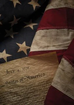 Close-up of Declaration of Independence resting on American flag Stock Photos