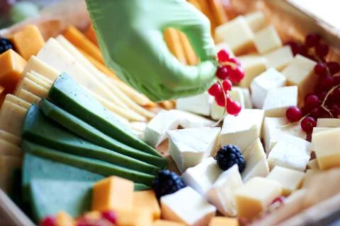 A close up of a decorated cake on a plate different cheeses Stock Photos