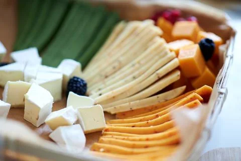 A close up of a decorated cake on a plate different cheeses Stock Photos