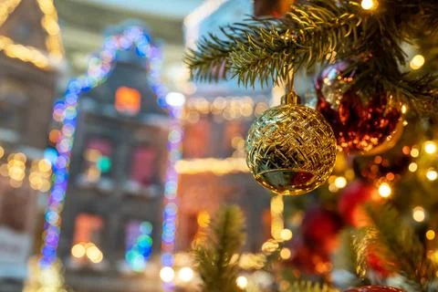 A close-up of a decorated Christmas tree on a background of city buildings Stock Photos