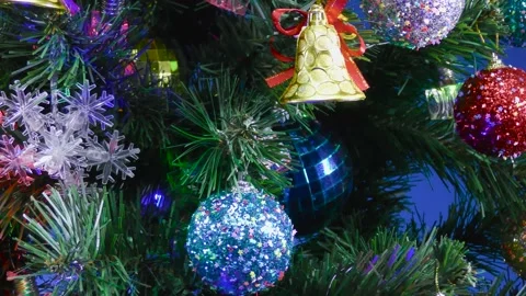 Close-up decorated Christmas tree with blinking garlands on a blue background Stock Footage 166706030