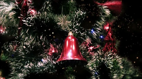 Close up of decorated Christmas tree at night with red bell and stardust Stock Footage 82472028