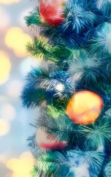 Close-up of a decorated Christmas tree with red baubles and bokeh lights Stock Photos