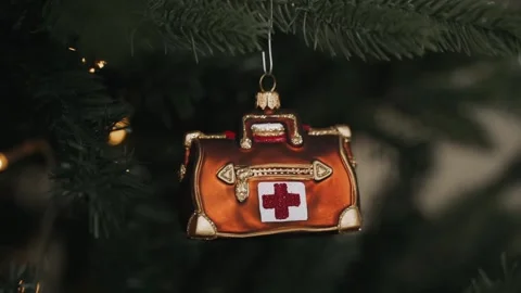 Close-up of decorating Christmas tree with doctor's bag. Stop coronavirus Stock Footage 166544522