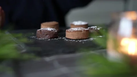 Close-up decorating a plate with typical Christmas sweets with icing sugar Stock Footage 163827198