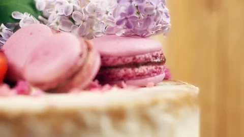 Close up of decoration on handmade cake with macaroons, sliced strawberries and Stock Footage 99388456