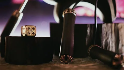 Close up of decorative dice and gaming elements on a dark surface with Stock Footage 325761279