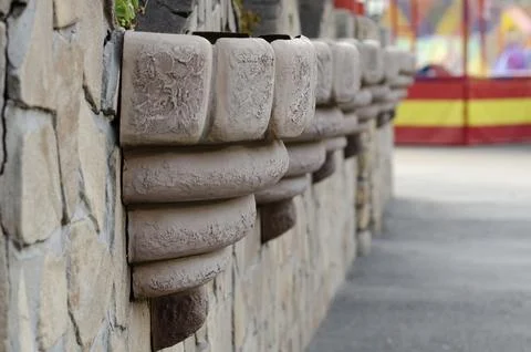 Close-up of decorative elements on a textured stone wall, with the ride's v.. Stock Photos