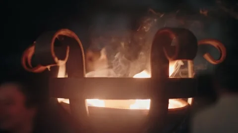 Close up of decorative iron brazier with glowing fire, creating a warm and Stock Footage 283063910
