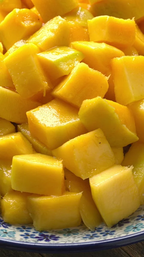 Close-up of a decorative plate with ripe mango chunks. Stock Footage 326462877