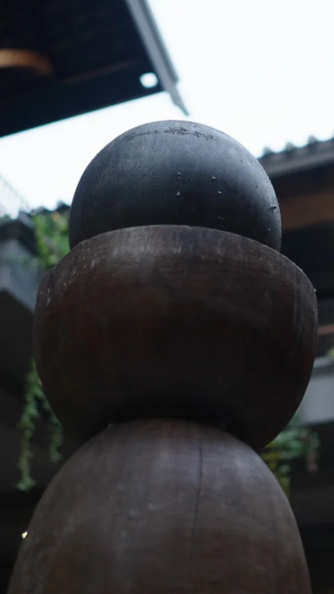 Close up of a decorative stone in a courtyard full of plants Stock Footage 265492788